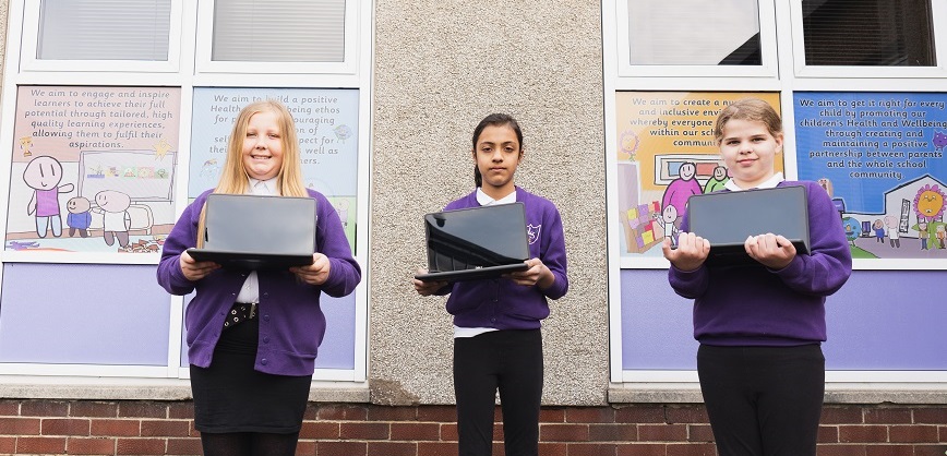 Langlees PS children holding donated laptops