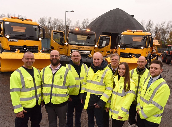 Roads staff in front of gritters