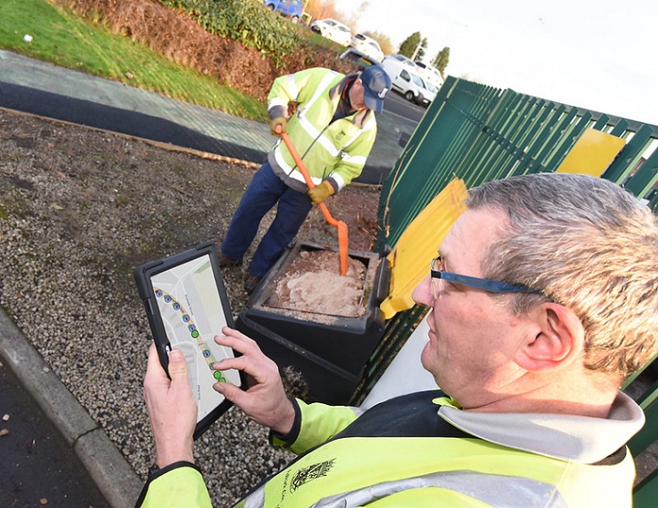 Roads & Grounds workers refill a grit bin that new software highlighted was nearly empty