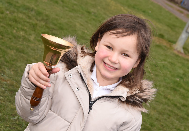 Mila Sneddon holds the bell which her teacher bought her